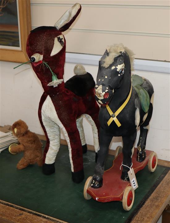 A childs fabric pull along horse and two others